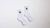 Pair of white socks with black logo on a light gray background
