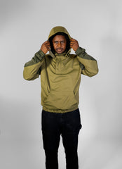 Person wearing a green raincoat against a white background