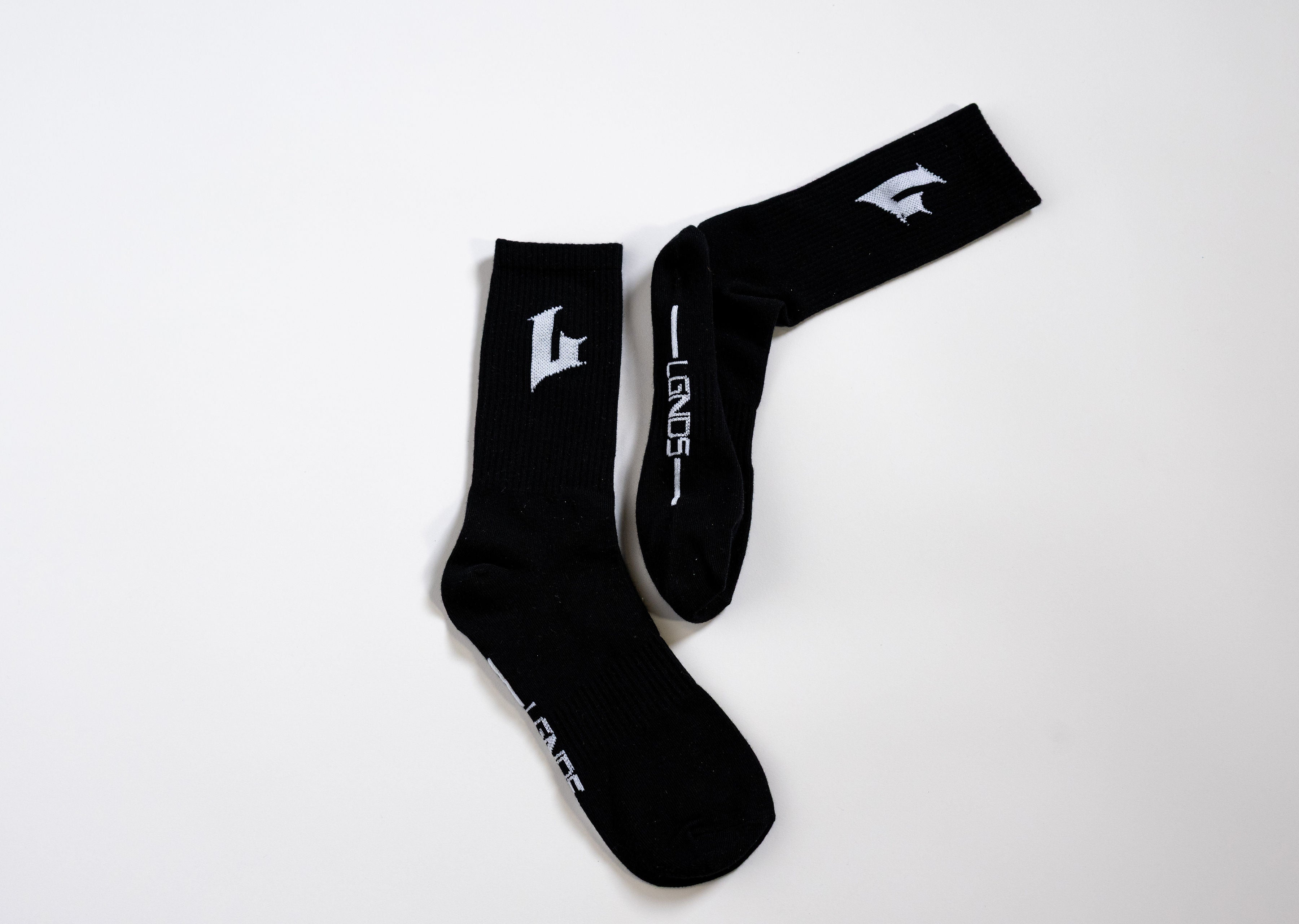Black socks with white branding on a white background