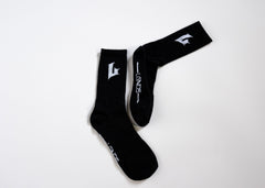 Black socks with white branding on a white background