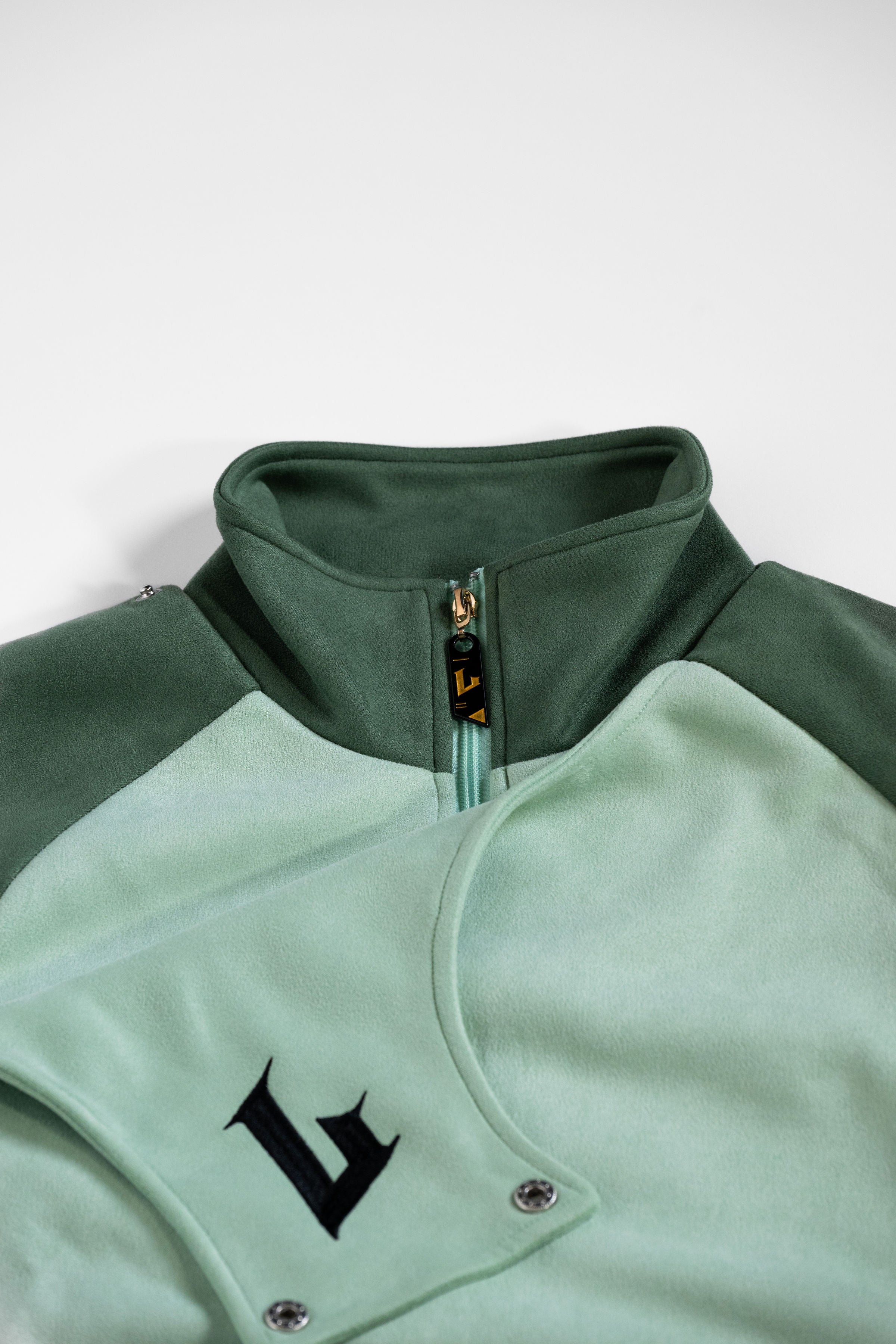 Green and light green jacket with a logo on a white background