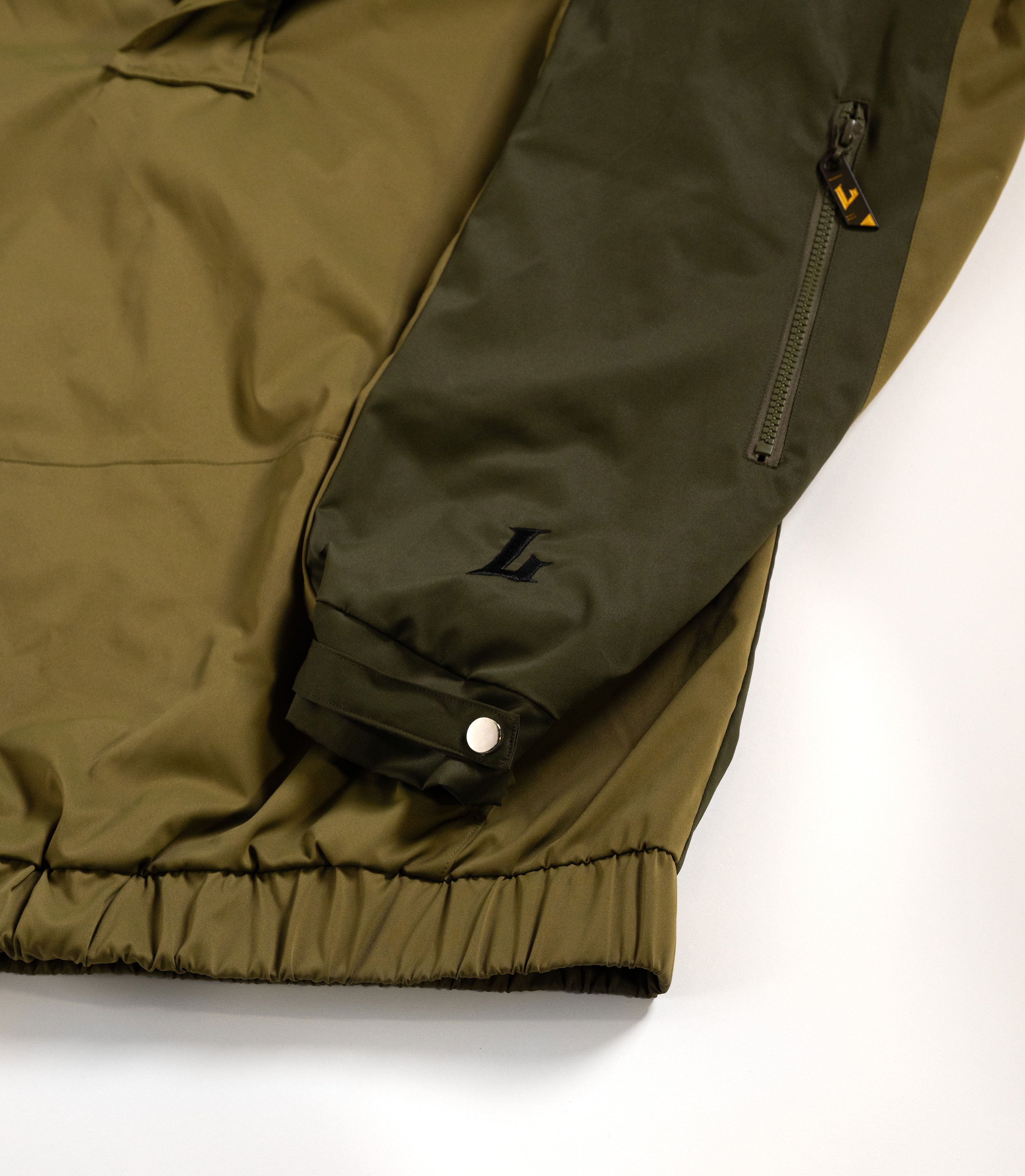 Close-up of a green jacket with a white background