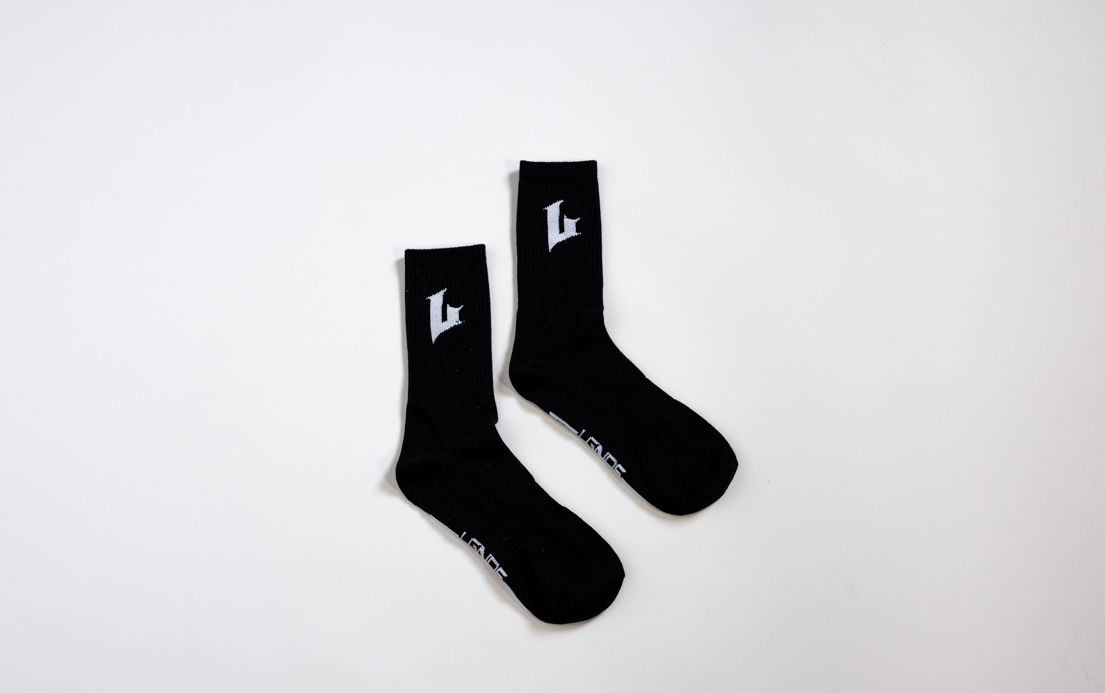 Pair of black socks with a logo on a white background