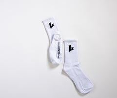 Two white socks with black logo on a light gray background